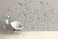 Enchanted Aviary Ballet mural of beige wildflowers and birds behind a white egg chair in a living room