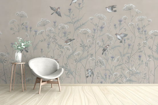 Enchanted Aviary Ballet mural of beige wildflowers and birds behind a white egg chair in a living room