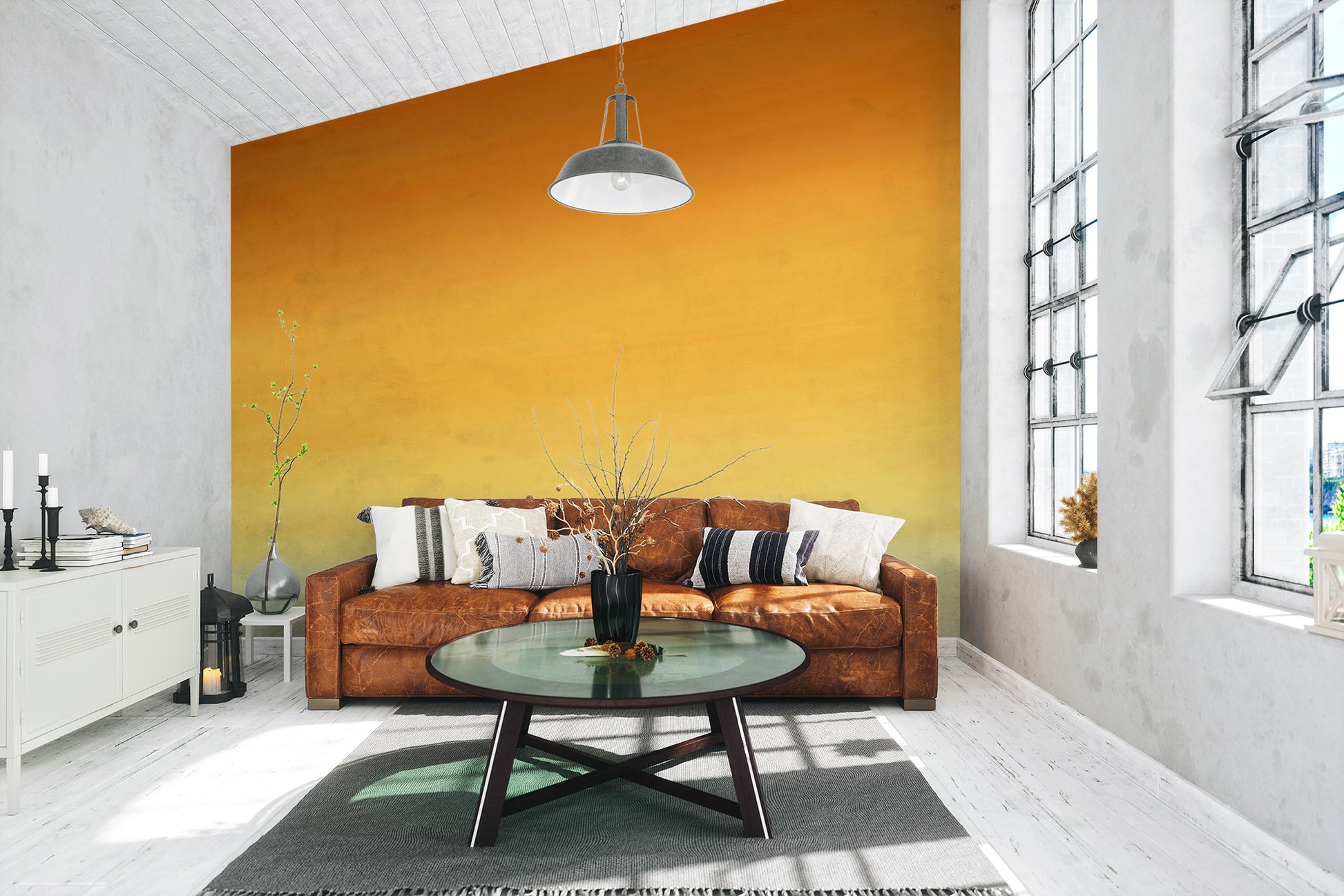 Honey Ombre wallpaper mural in warm yellow to orange behind a tan leather sofa and round glass coffee table