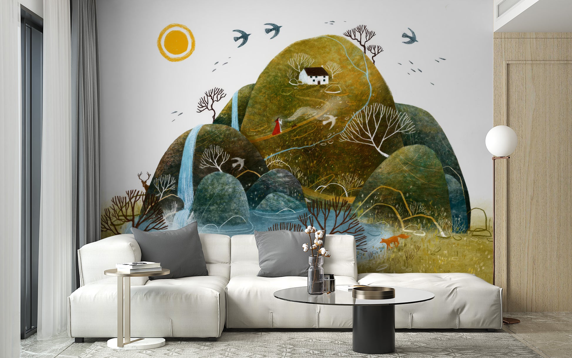 Serene Nature wallpaper mural showing green hills, a waterfall and red figure behind a white sofa with grey cushions in a living room