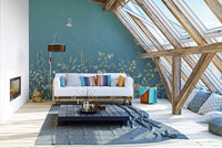 Twilight Flutters wallpaper mural of teal foliage and birds behind a white pallet sofa in a skylit attic lounge