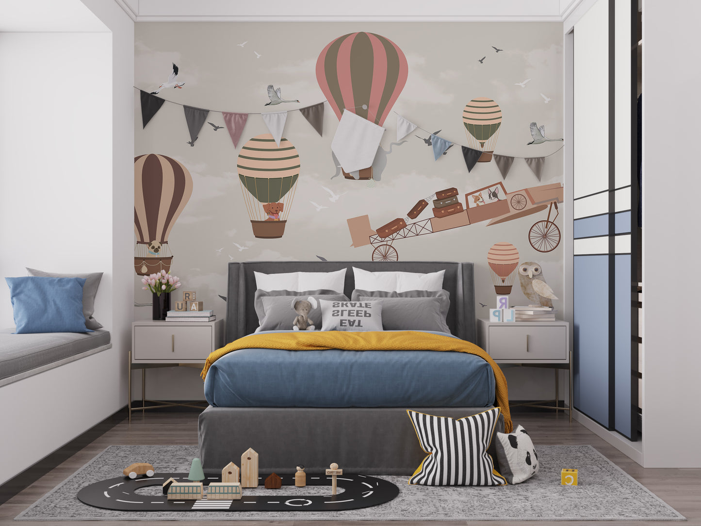 Whimsical Sky High Adventure wallpaper mural of balloons and an airplane above a grey bed with mustard throw in a kids bedroom