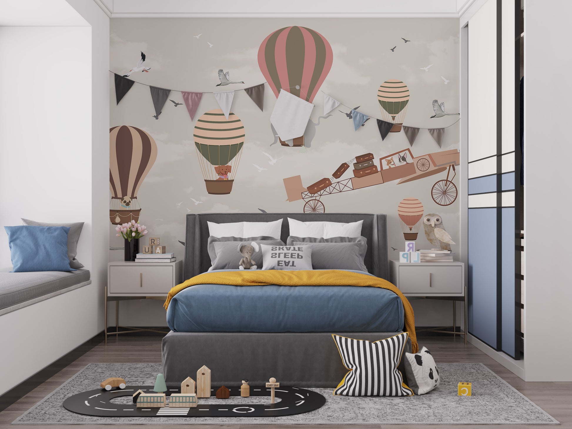 Whimsical Sky High Adventure wallpaper mural of balloons and an airplane above a grey bed with mustard throw in a kids bedroom