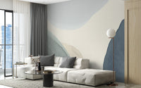 Calming Contours wallpaper mural of muted contour shapes behind a cream sofa in a city-view living room