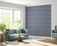 Repeating leaf motif wallpaper in soothing gray and cream tones for a serene look.