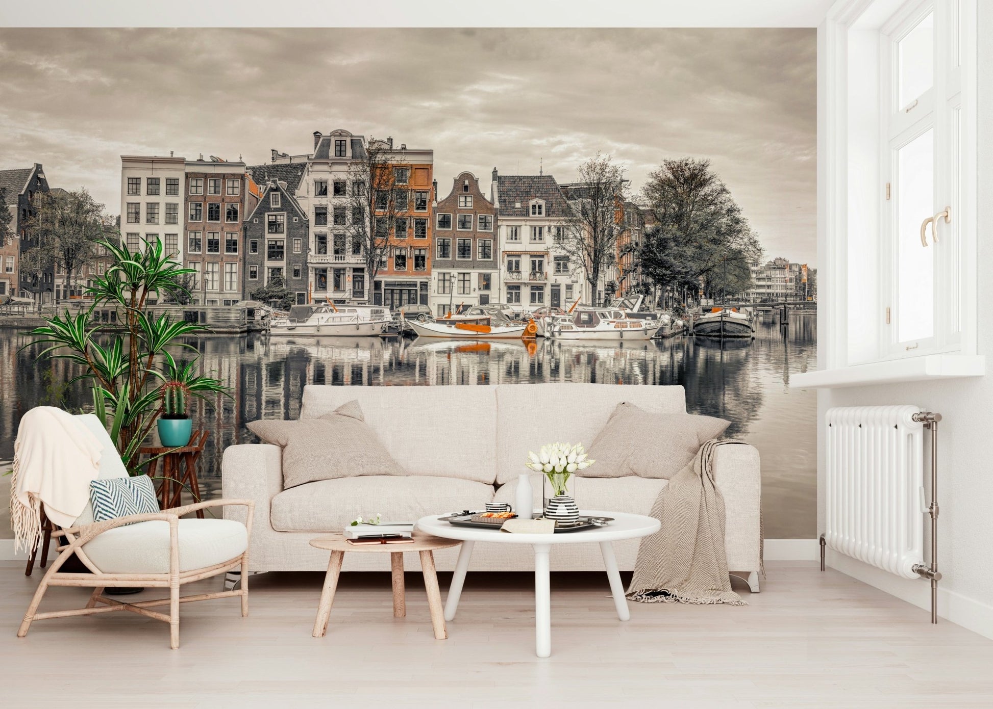 Canal Harmony wallpaper mural of a sepia Amsterdam canal behind a cream sofa and rattan chair in a bright living room
