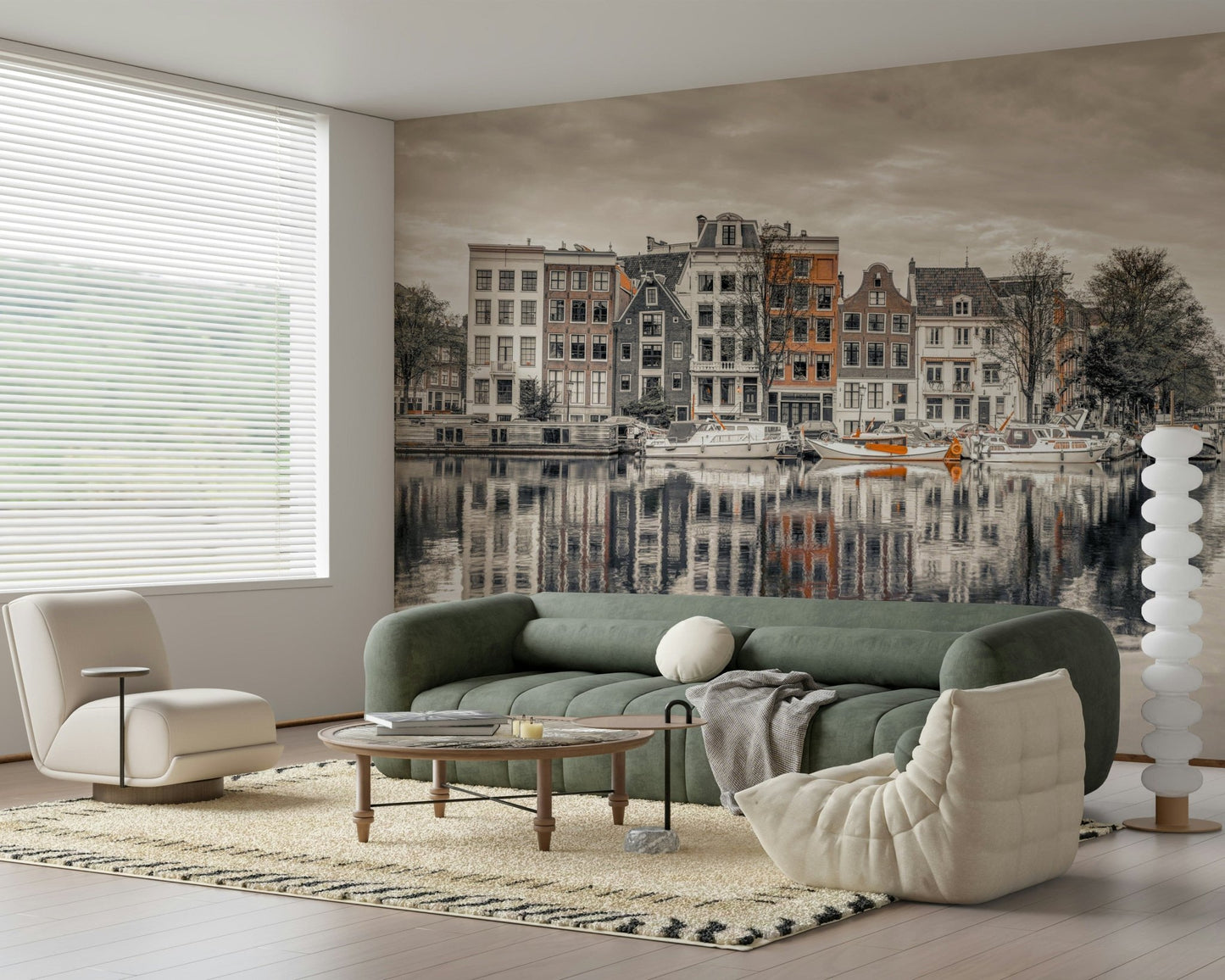 Canal Harmony wallpaper mural of gabled canal houses reflected in water behind a green sofa and cream chair in a living room