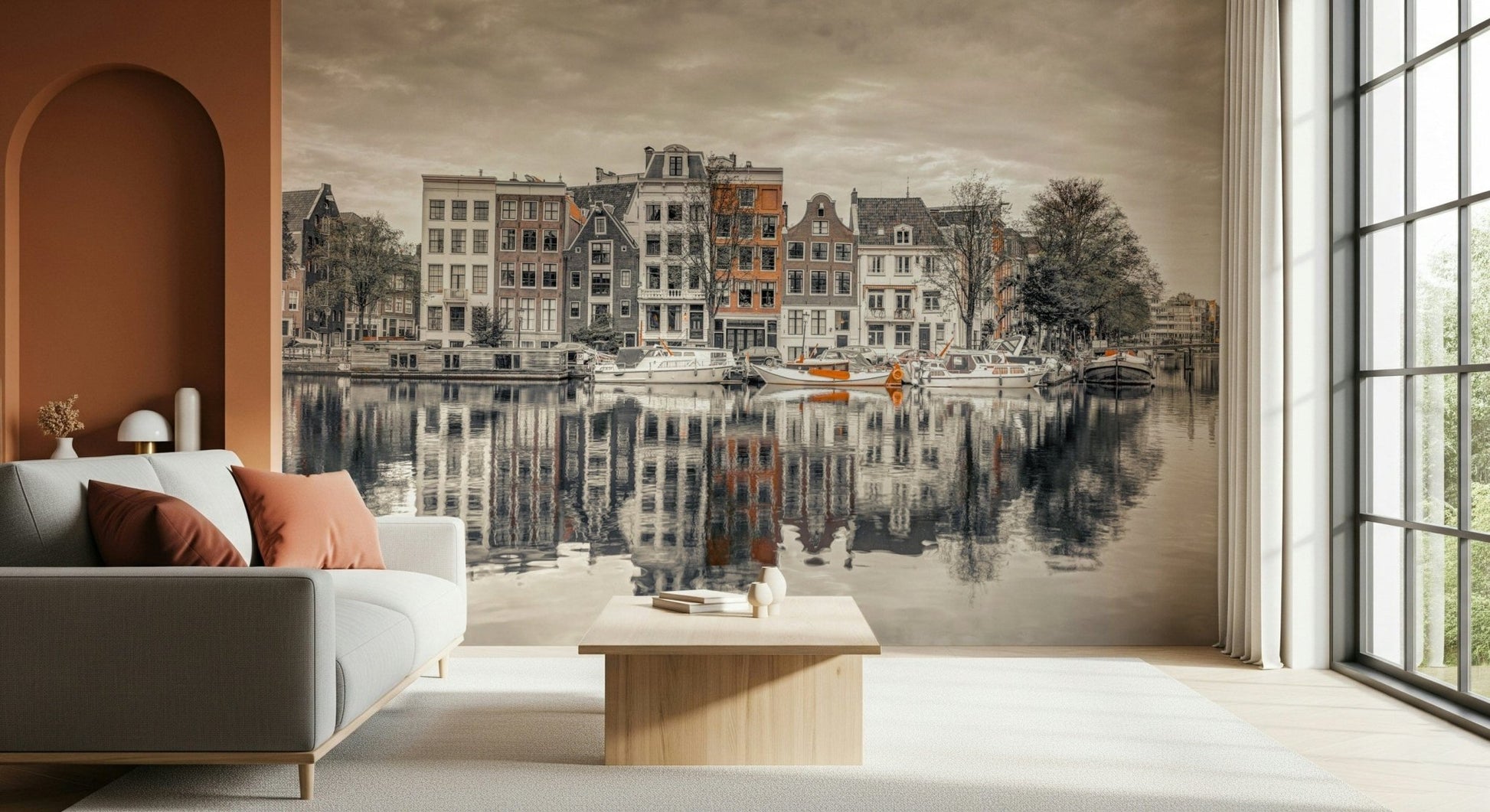 Canal Harmony wallpaper mural of sepia canal houses reflected in water behind a gray sofa beside a terracotta arch alcove
