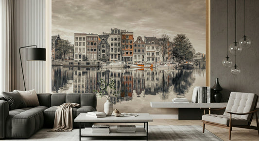 Canal Harmony wallpaper mural of gabled canal houses and boats behind a dark gray sofa and white tufted chair in a lounge
