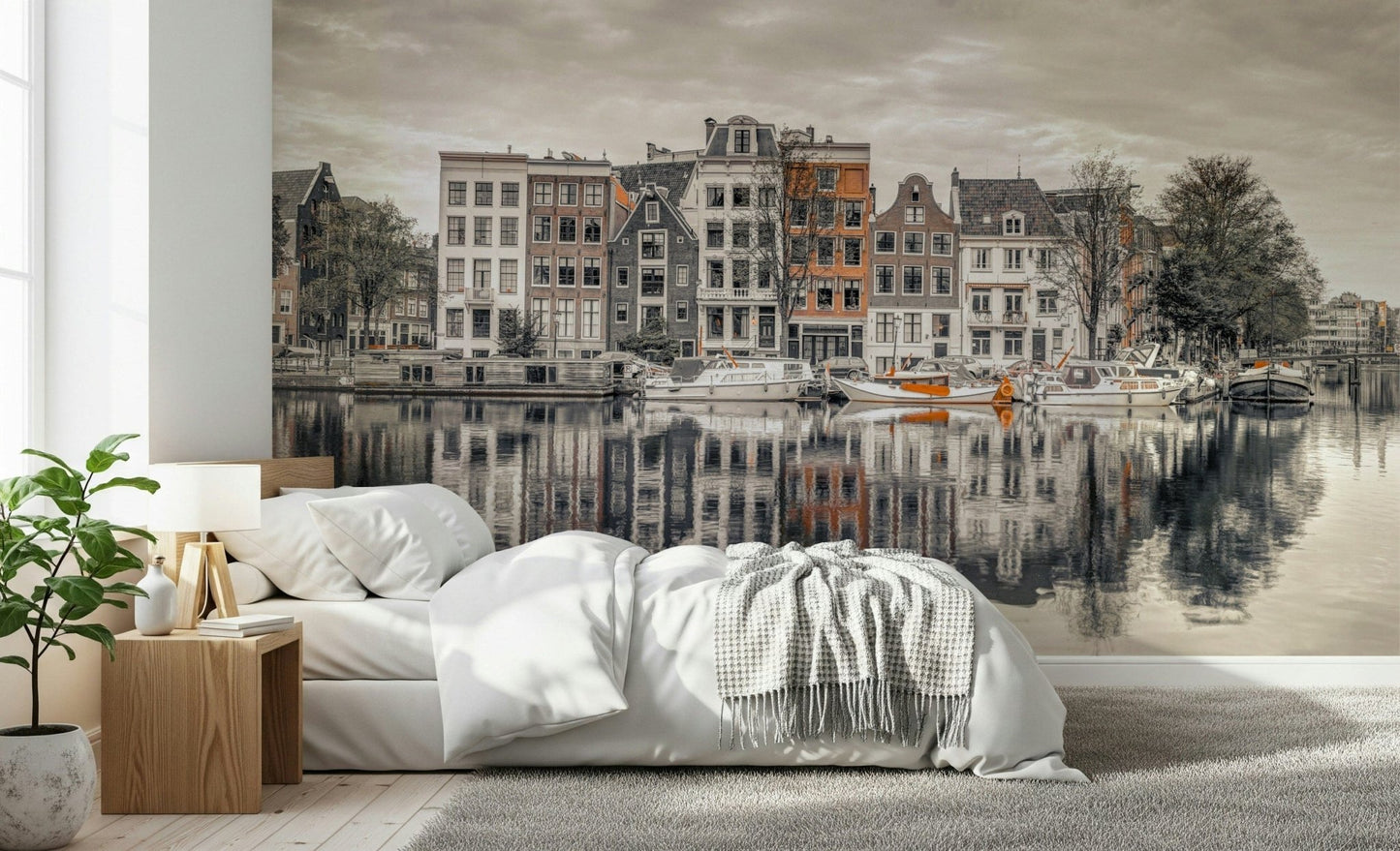Canal Harmony wallpaper mural of sepia gabled houses along a canal behind white bedding and a wood nightstand in a bedroom