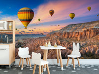 Cappadocia Balloons Sunset wallpaper mural in a kids room with a play kitchen and white bear chairs on a dotted rug
