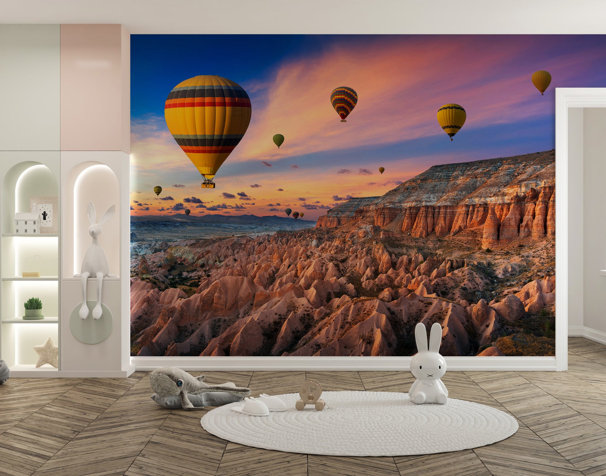 Cappadocia Balloons Sunset wallpaper mural of hot air balloons over rocky valleys in a white nursery with bunny decor