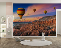 Cappadocia Balloons Sunset wallpaper mural of hot air balloons over rocky valleys in a white nursery with bunny decor