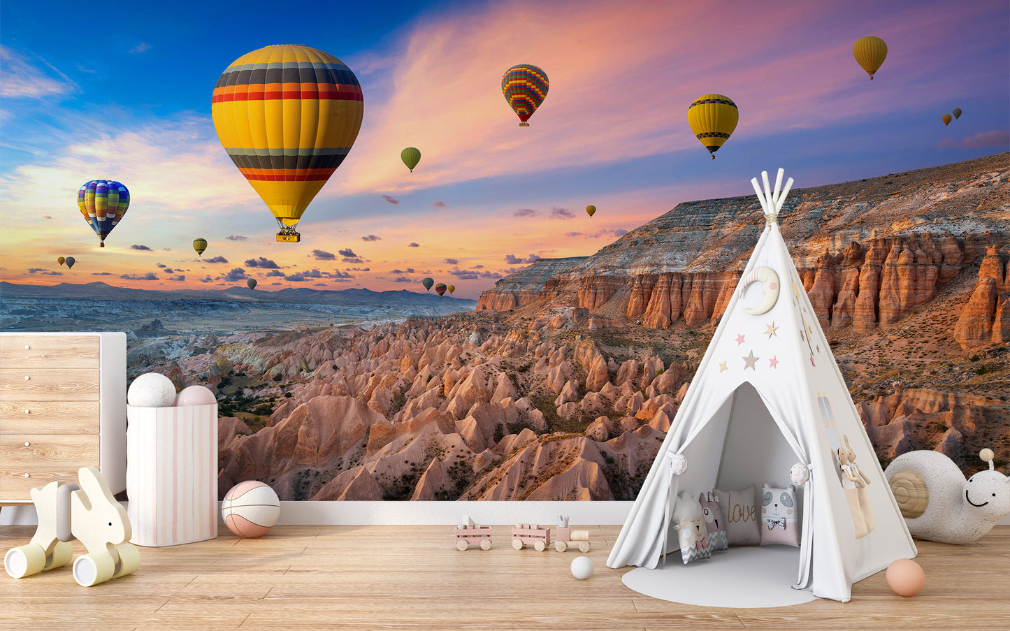 Cappadocia Balloons Sunset wallpaper mural with balloons at dusk behind a white teepee tent in a kids playroom