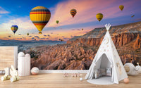 Cappadocia Balloons Sunset wallpaper mural with balloons at dusk behind a white teepee tent in a kids playroom