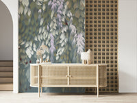 Cascading Wisteria Dream wall mural in green and lilac behind a rattan cane sideboard in an entryway