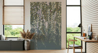 Cascading Wisteria Dream wall mural in green and lilac behind a wood desk in a bright home office