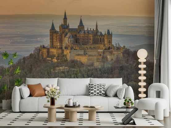 Castle Majesty wallpaper mural of a hilltop castle at sunset behind a white sofa in a bright living room
