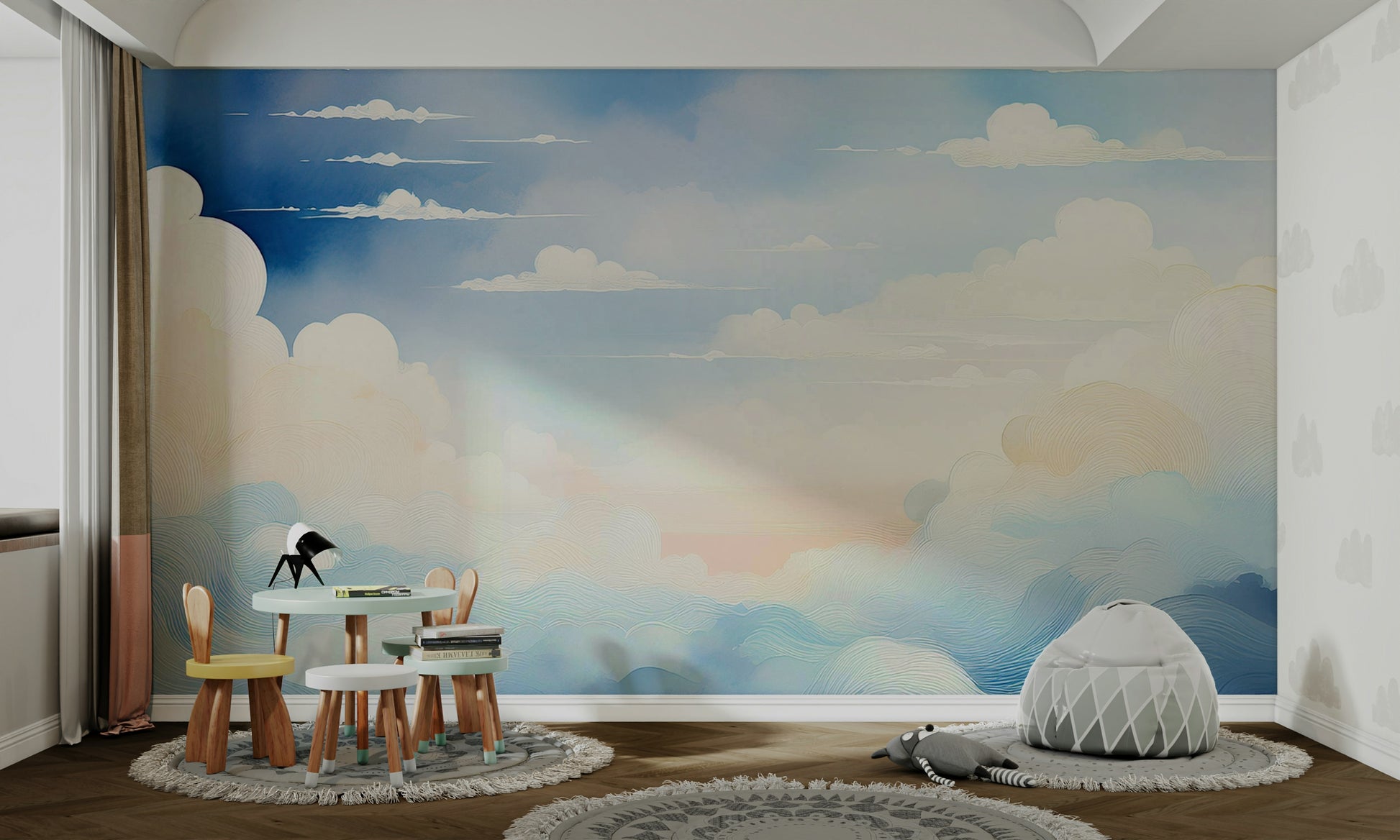 A nursery room featuring a light blue sky pattern on the main wall.