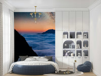 Wide valley mural showing misty mountains and open sky tones, gentle cloud wallpaper style