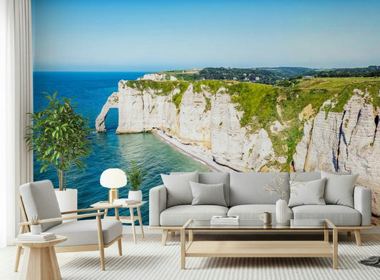 Chalk Cliffs Vista wallpaper mural of white cliffs and turquoise sea behind a grey sofa and armchairs in a living room