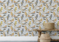 Birds Golden and Gray wallpaper as a full-wall mural behind a rustic wood bench and seagrass baskets