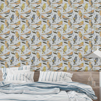 Birds Golden and Gray wallpaper behind a bed dressed in blue striped bedding in a relaxed bedroom