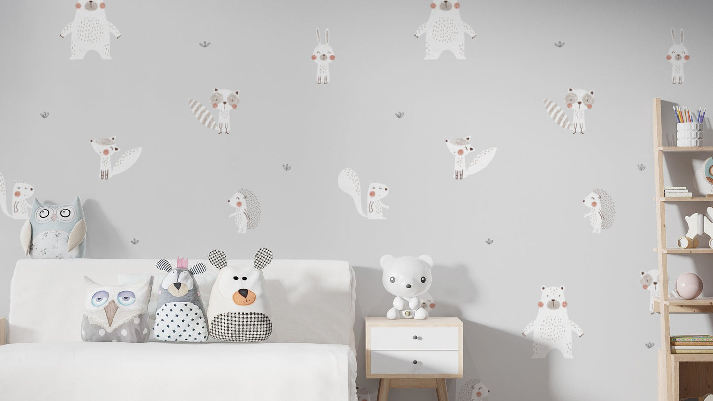 Forest Animals Gray wallpaper behind a white bed with owl and bear plush cushions in a grey kids room