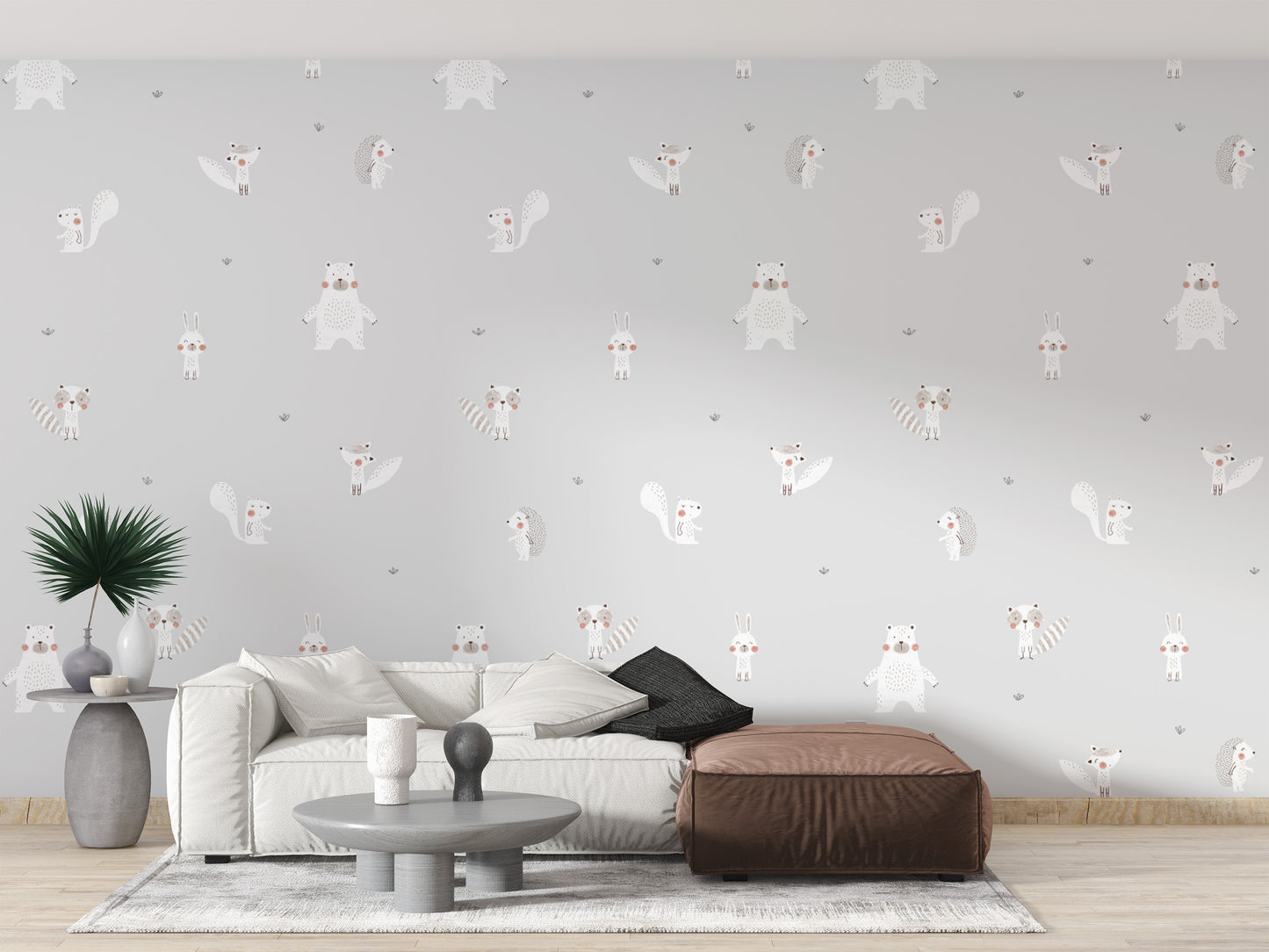 Forest Animals Gray wallpaper behind a white sofa and brown leather ottoman in a grey living room
