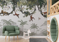 Cheeky Hanging monkeys wallpaper mural of jungle monkeys behind a green armchair and rocking horse