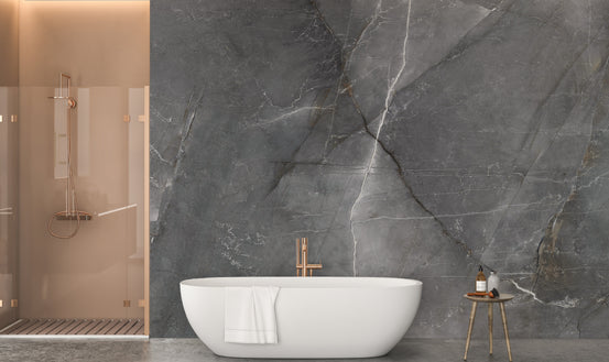 Chic Dark Marble Texture wallpaper mural in veined grey stone behind a white freestanding tub and copper shower