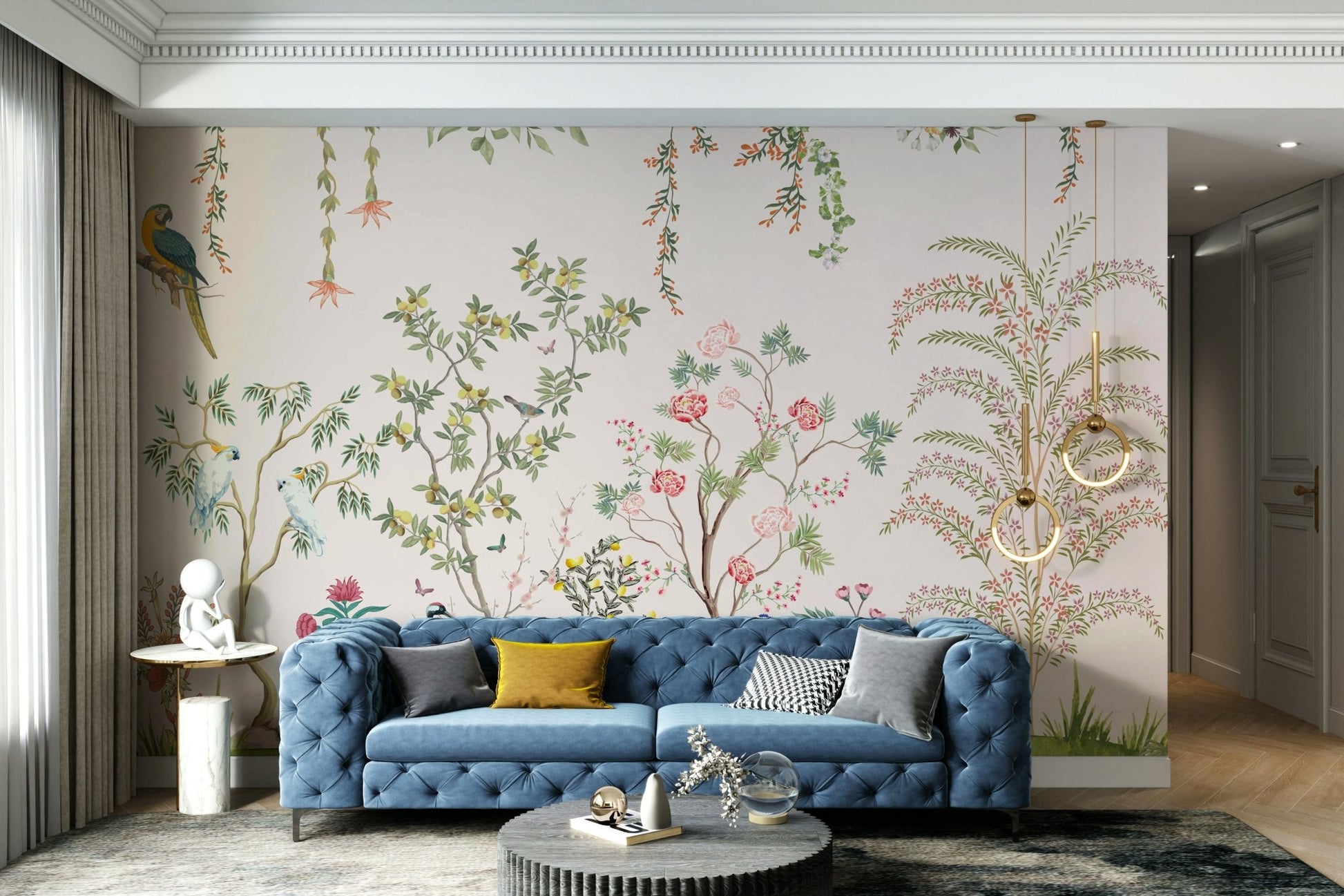 Chinoiserie Garden wallpaper mural with parrots behind a blue tufted sofa with a mustard pillow in a living room