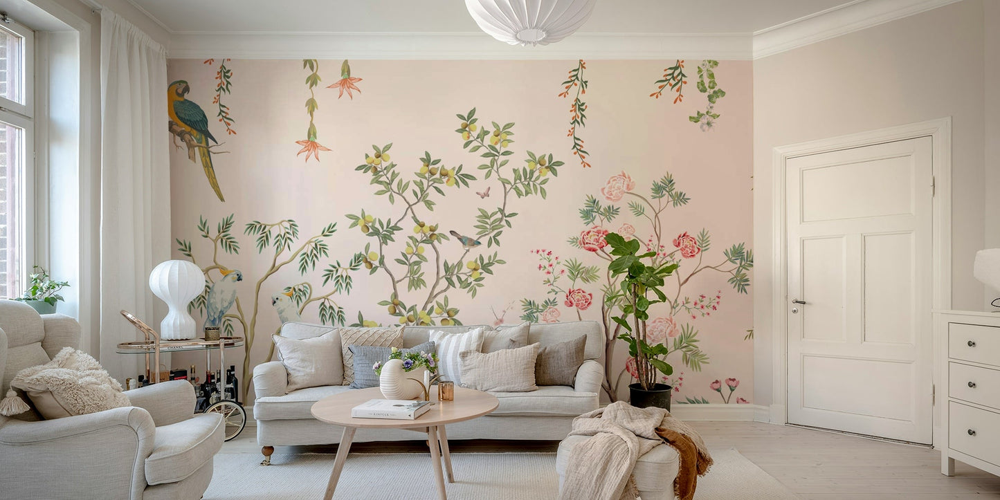 Chinoiserie Garden wallpaper mural with parrots behind a grey sofa with a fiddle-leaf plant and drinks cart
