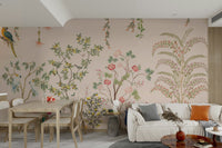 Chinoiserie Garden wallpaper mural with parrots behind a white sofa and wooden dining table in an open living room