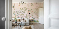 Chinoiserie Garden wallpaper mural with peacocks viewed through a doorway behind a white sofa in a living room