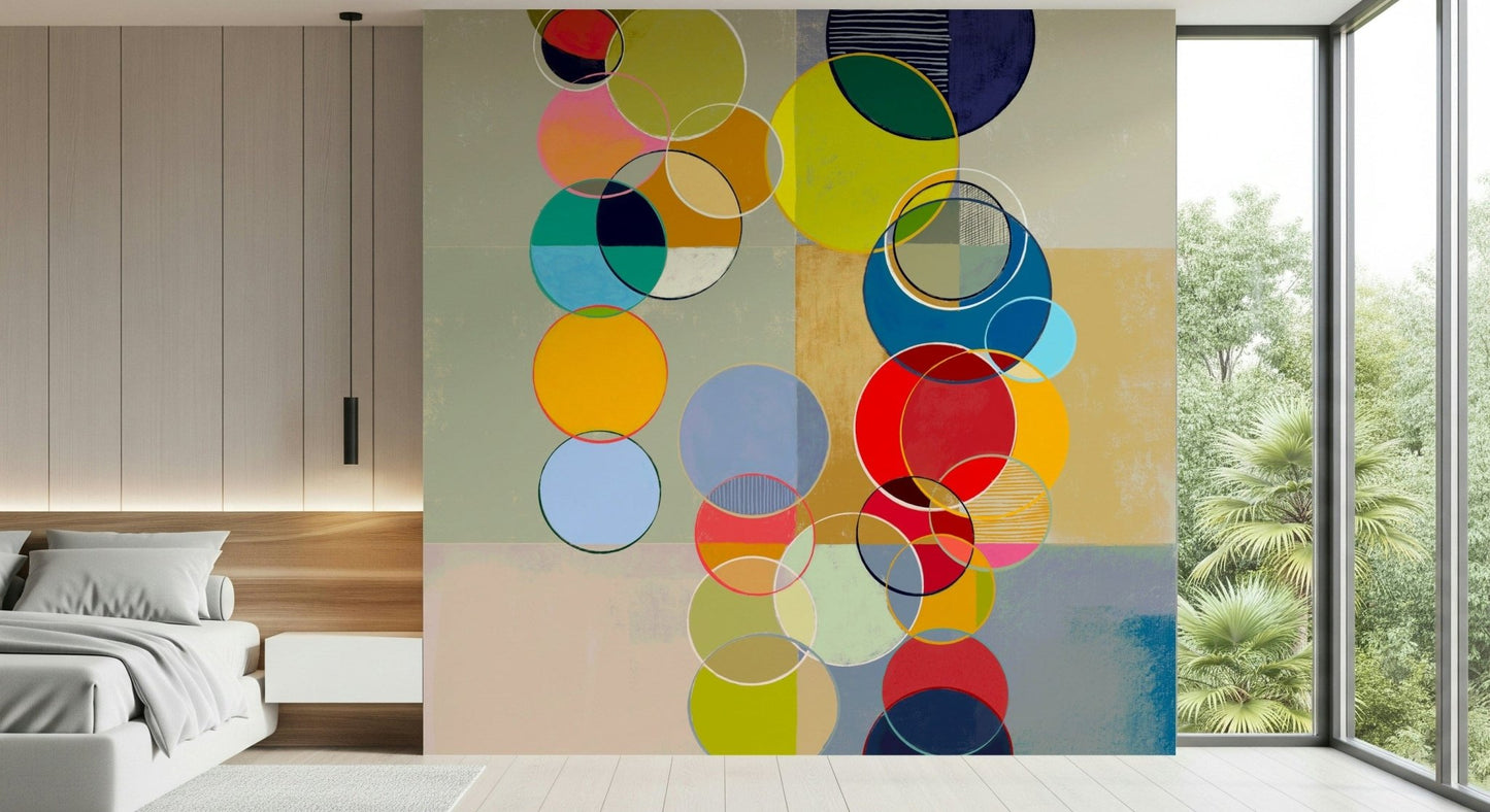 Chromatic Circles wallpaper mural with translucent circles above a low white bed beside a garden window