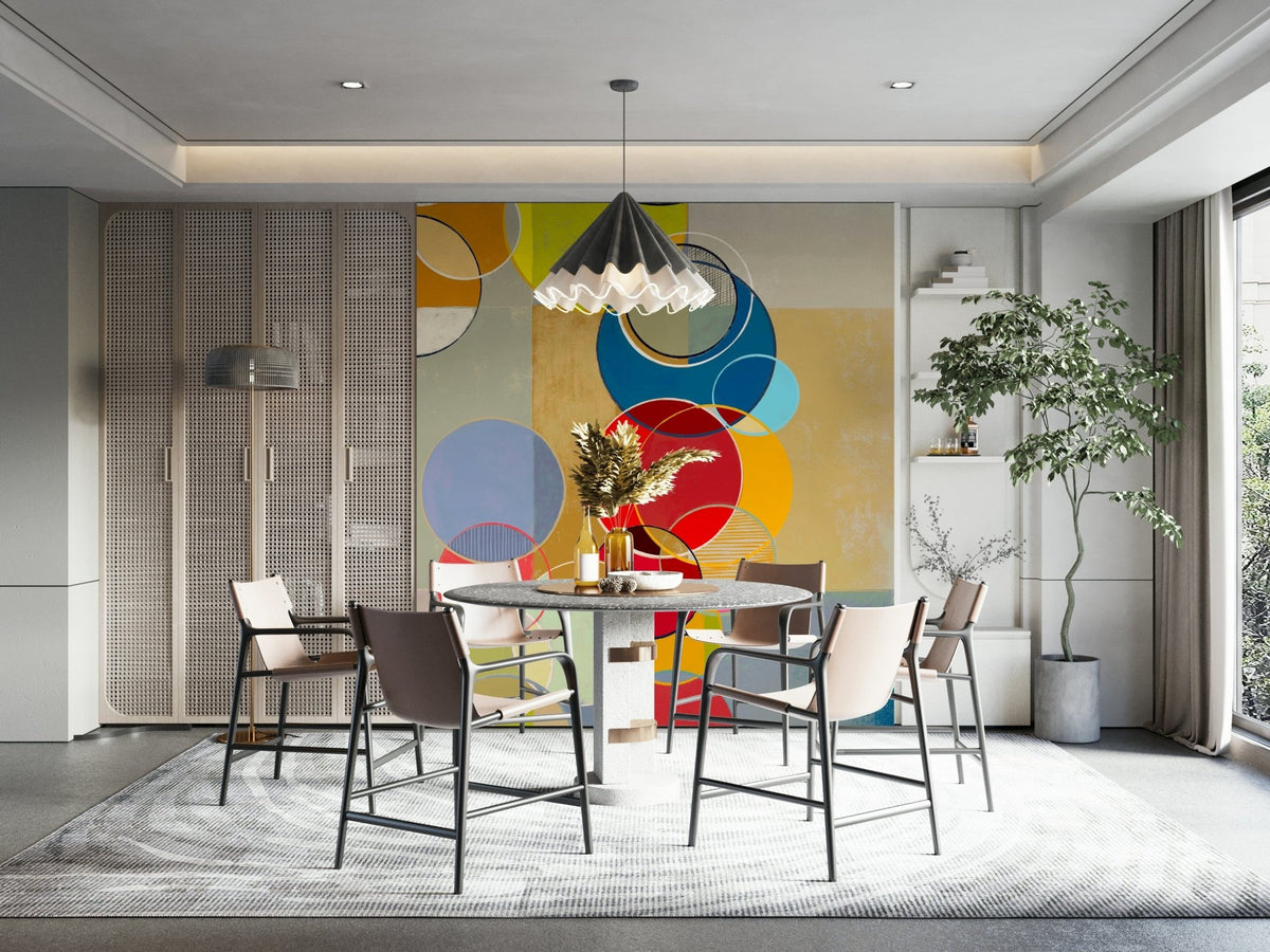 Chromatic Circles wallpaper mural with colorful circles behind a round terrazzo dining table and pleated pendant
