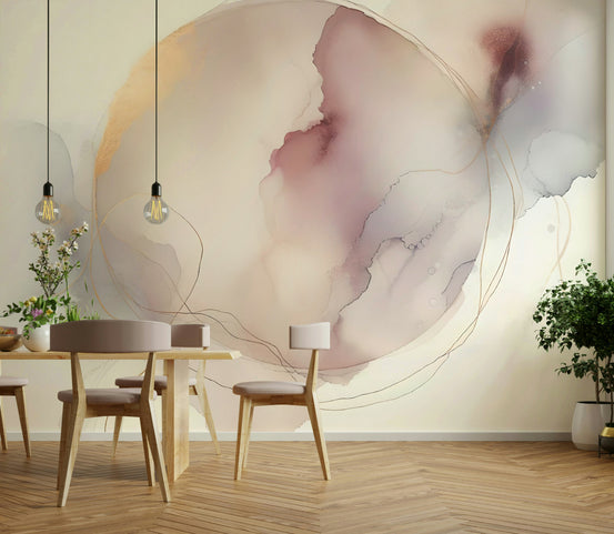 Circle of Serenity wallpaper mural with a blush and gold ink circle behind a light wood dining table and Edison bulbs