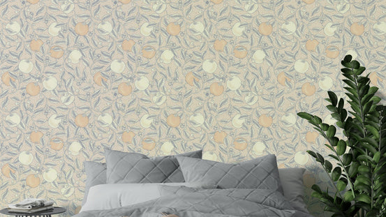 Citrus Squeeze in Neutral Botanica wallpaper with peach and cream fruit behind a gray bed and green plant