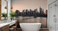 City Lights at Dawn wall mural of the skyline at sunset behind a white freestanding tub in a marble bathroom