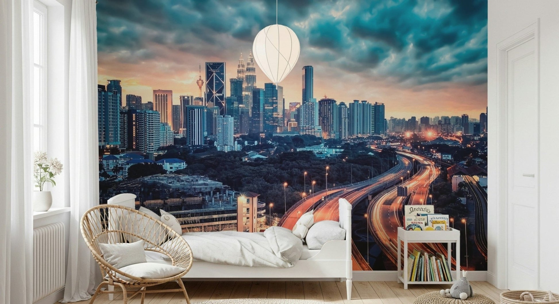 Cityscape Dawn wallpaper mural of the dusk city skyline above a white bed and rattan chair in a bedroom