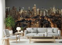 Cityscape Twilight wallpaper mural of a city skyline behind a grey sofa and armchair in a living room
