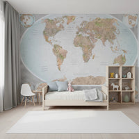 Classic world map in blue and earthy tones wallpaper mural behind a wood daybed and white Eames chair in a kids room