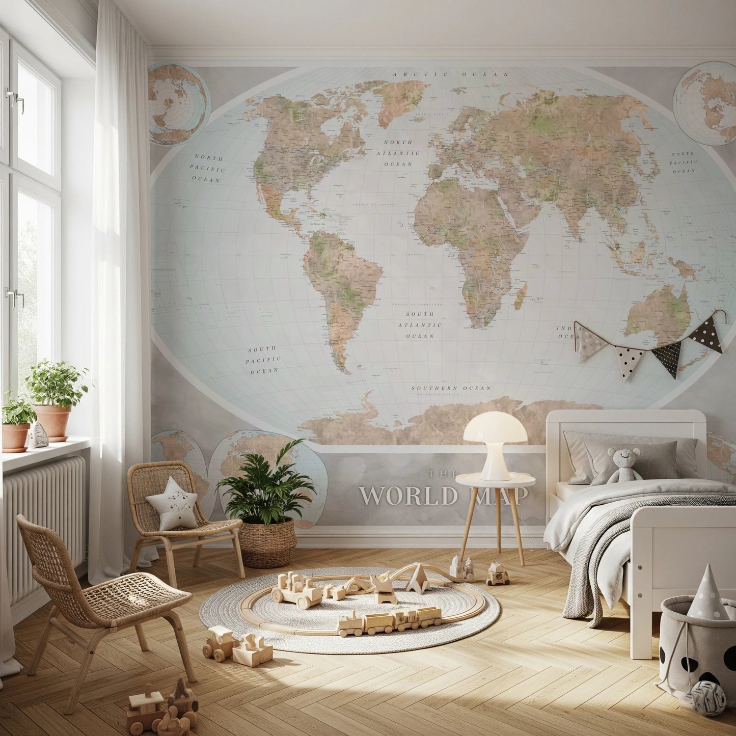 Classic world map in blue and earthy tones wallpaper mural above a white bed and rattan chairs in a soft kids room