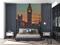 Clock tower wallpaper mural of Big Ben at sunset in a navy bedroom with a grey bed and globe pendant