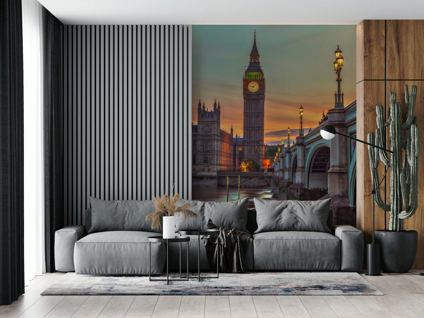 Clock tower wallpaper mural of Big Ben at sunset behind a grey sofa with a tall cactus in a living room