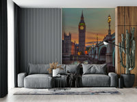 Clock tower wallpaper mural of Big Ben at sunset behind a grey sofa with a tall cactus in a living room