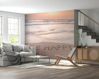 Coastal Affirmation wallpaper beach sand writing "Be Happy" waves mural.