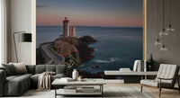 Wall mural depicting a lighthouse by the sea, creating a serene coastal ambiance.