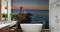 Coastal Beacon Serenity Wall Mural featuring a lighthouse overlooking calm ocean waters at sunrise.